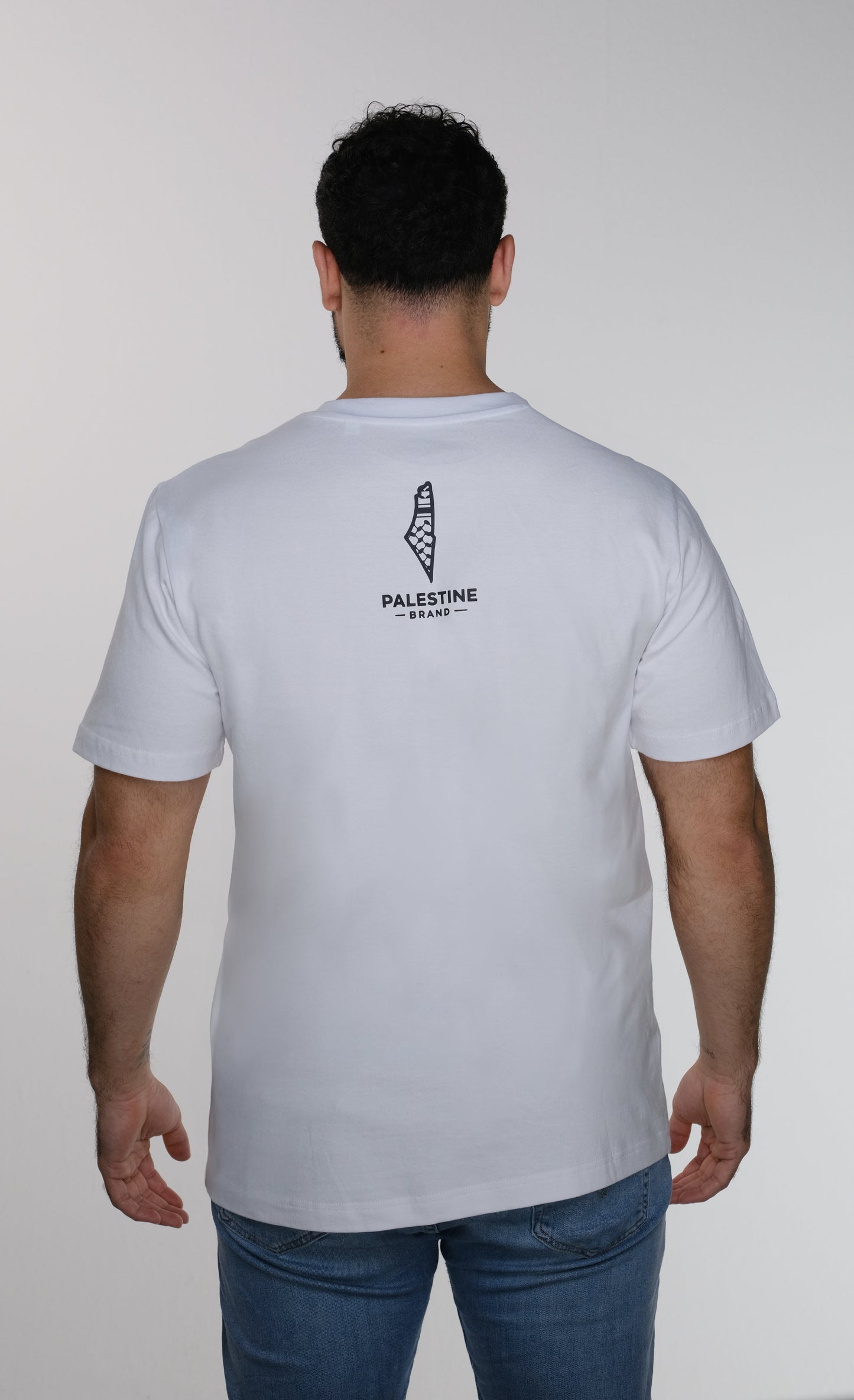 Model back view of the sumud T-shirt which is featuring Palestine Brand logo design.
it is Palestine map with keffiyeh colors