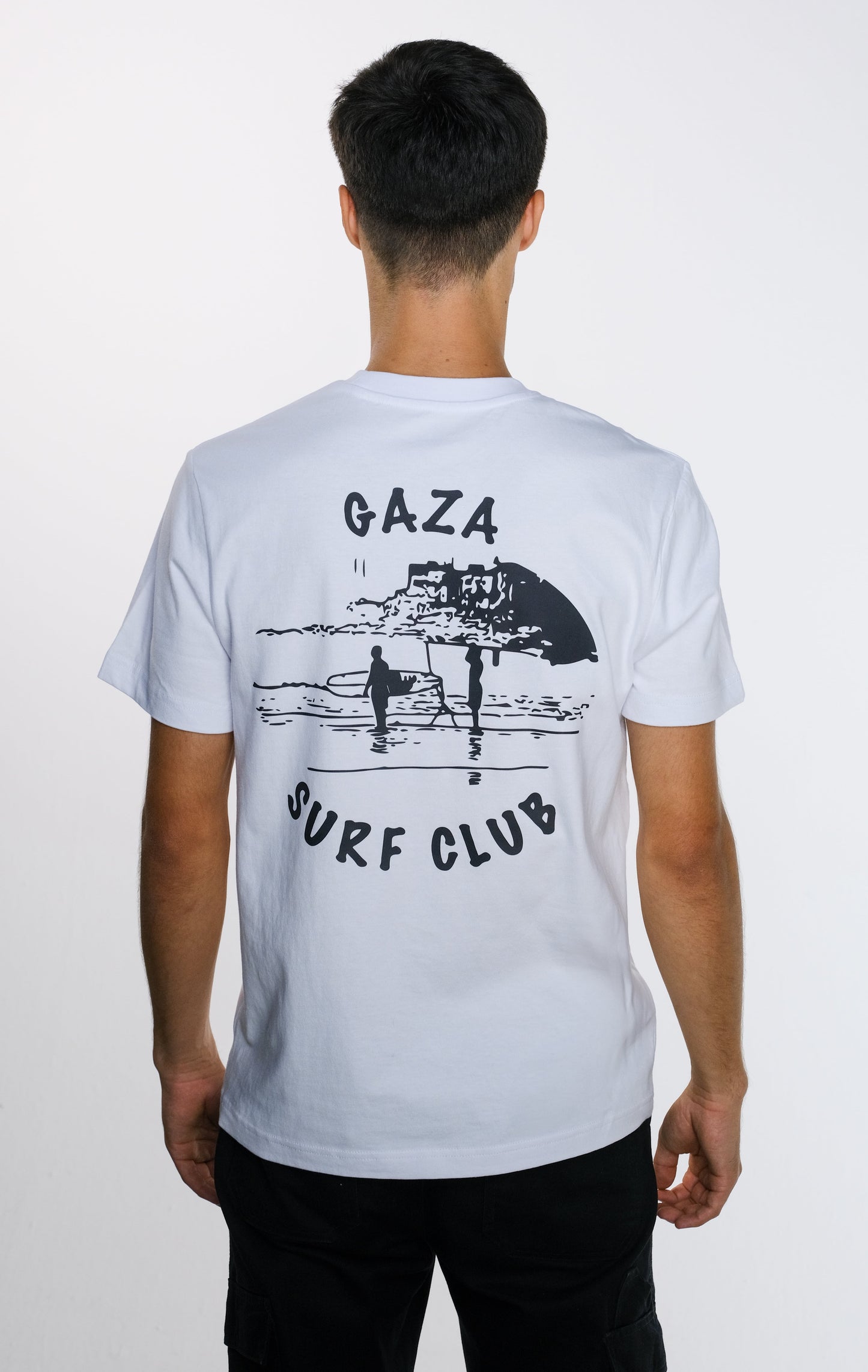 Back view of the model wearing the Gaza Surf Club t-shirt, displaying the bold back print design that celebrates Gaza’s surf culture and freedom.