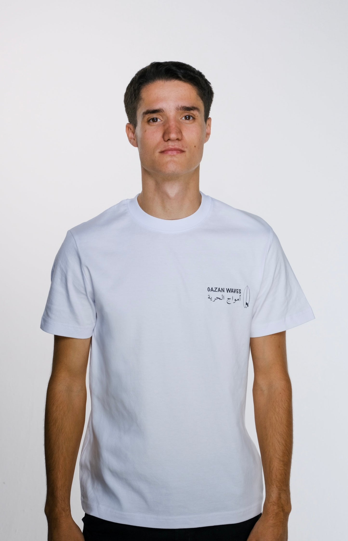 Model wearing the Gaza Surf Club t-shirt facing forward, showing the small front design. Casual, loose fit reflecting streetwear style and coastal vibes.