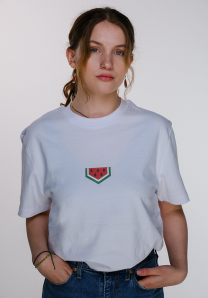 A young model wearing the watermelon T-shirt, standing confidently.
 The red-green-black colors of the watermelon design evoke the Palestinian flag and resistance.