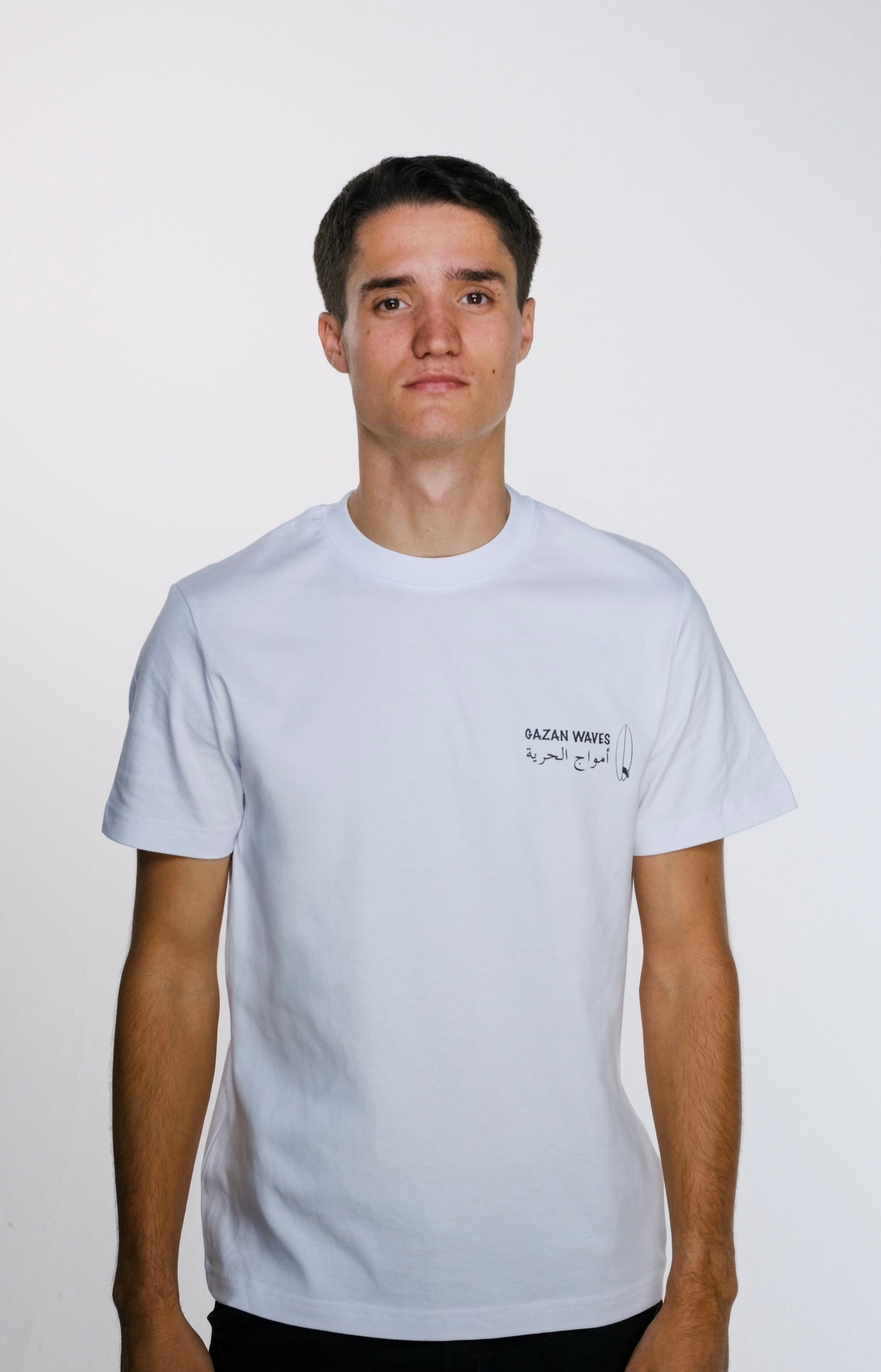 Model wearing the Gaza Surf Club t-shirt facing forward, showing the small front design. Casual, loose fit reflecting streetwear style and coastal vibes.