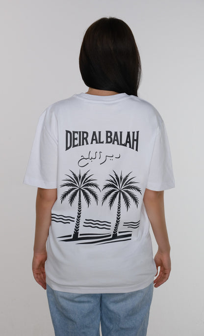Model wearing the Deir al-Balah T-shirt, back view showcasing the length and drape of the fabric, with a date palm tree design symbolizing the city's heritage.